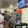 Trevor M. Rosato, a culinary arts and systems student from Jersey Shore, speaks with Chef Facchini through the AVer VC520.