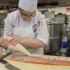 Magdalen C. Bennett, of Erie, pipes a sea scallop-lobster mousse onto a salmon filet for the first course.