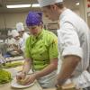 During a dinner prep session on Thursday, Chef Kristi Ritchey shows student Lewis D. Robinson how to cut romanesca for Friday’s menu.