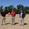 Craig M. Hartz (left), director of field operations at Warfel Construction, and Pennsylvania College of Technology alumnus Brad A. Shulenberger (center), Warfel's vice president of construction services, visit the heavy construction equipment operations site in Brady Township with Chris S. Macdonald, the college's assistant director of corporate relations.