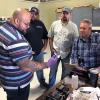 Jorge Alvarez, field engineer for Cambridge Vacuum Engineering, discusses components of an electron beam welder with Penn College faculty during a recent training session at the company’s U.S. sales office in Agawam, Mass. From left are welding instructors Aaron E. Biddle, Ty E. Rhinehart and Ryan P. Good.